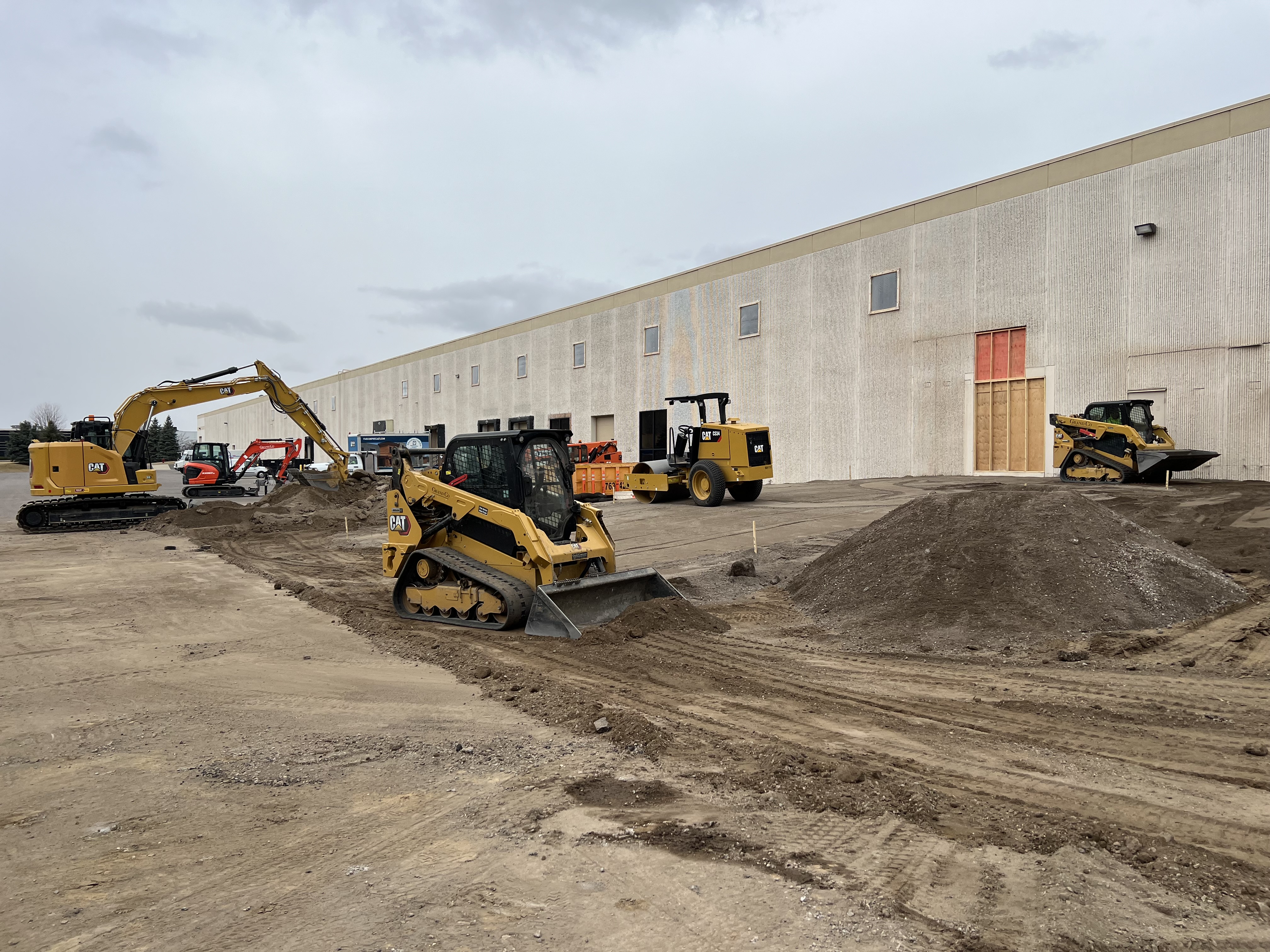 Grading and excavation equipment preparing a construction site