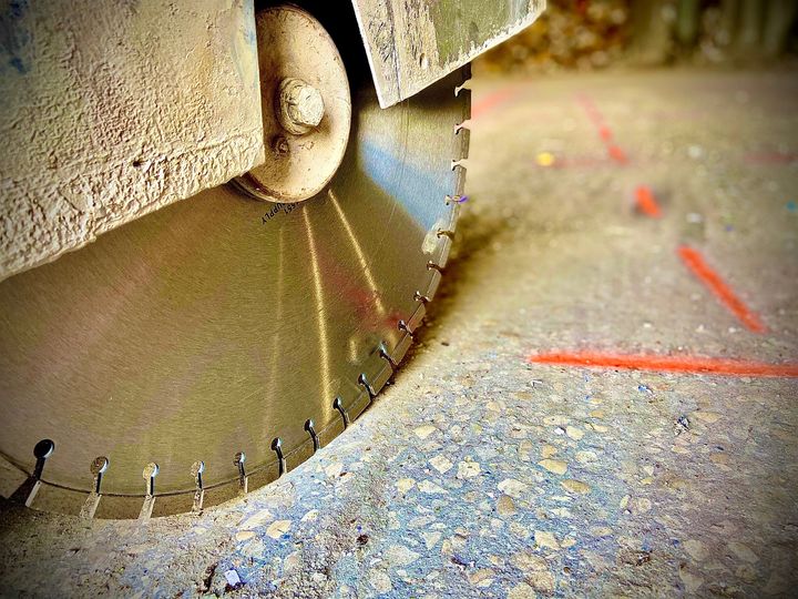 Concrete saw cutting through a slab on a Grand Companies project