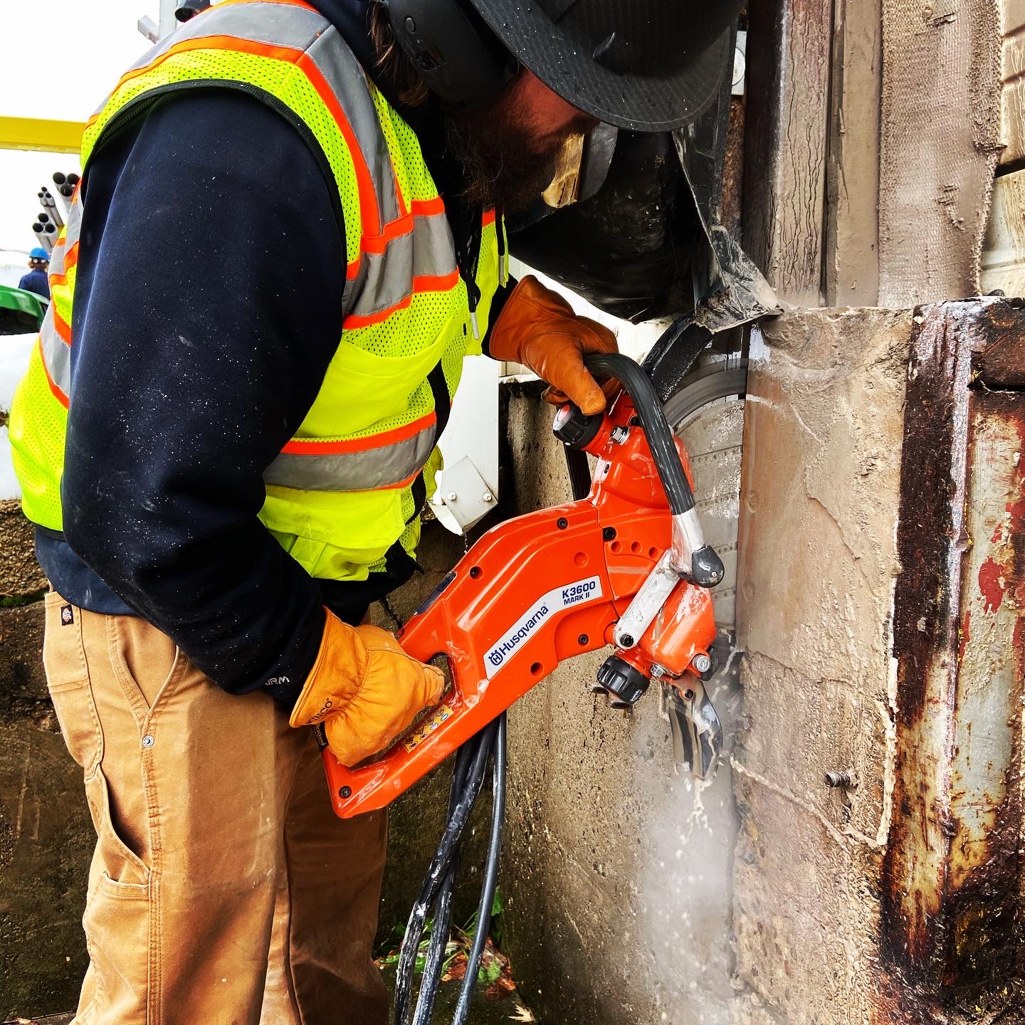 Operator making a precise cut with a hand-held concrete saw